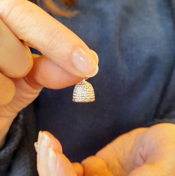 Our Shakespeare thimble charm being held ideal addition for a bracelet or necklace.