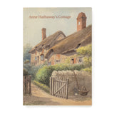 Souvenir notebook saying Anne Hathaway's Cottage. It features an atmospheric pastel watercolour painting of the cottage with the gate open and a basket and gardening tools positioned next to it.