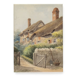 Souvenir fridge magnet featuring an atmospheric pastel watercolour painting of Anne Hathaway's Cottage, with the garden gate open and a basket and gardening tools positioned next to the fence.