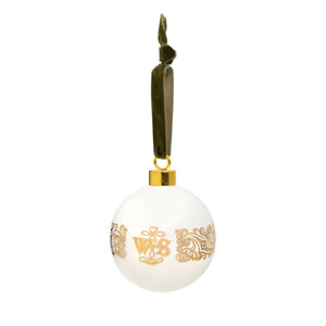 White ceramic bauble decoration with golden patterns from the First Folio and Shakespeare's initials, hung from a green velvet ribbon.
