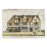 Souvenir tea towel  featuring an old coloured drawing of Shakespeare's Birthplace, with a dog in the foreground. Under the drawing the handwritten text says 'The House in Stratford upon Avon, in which Shakespeare was born'.