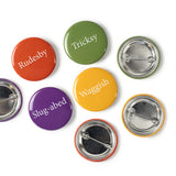 Four bright colourful (yellow, red,green and purple) button badges on a white background.